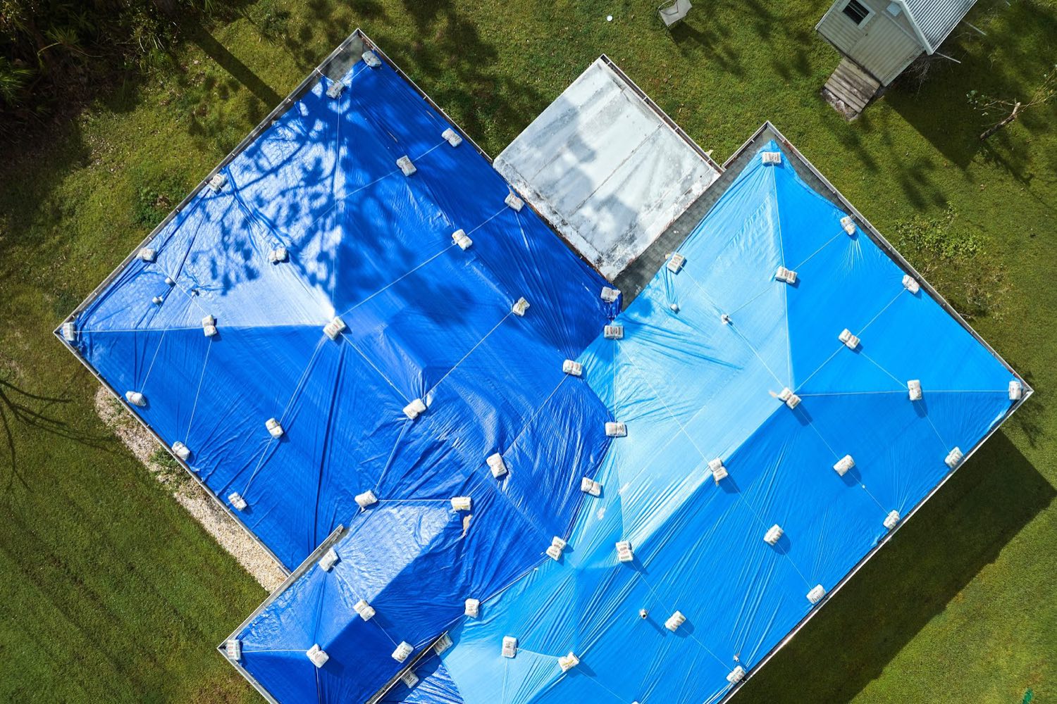 Aerial view of a Central Florida home fully tarped after storm damage by OnSite Emergency Tarping